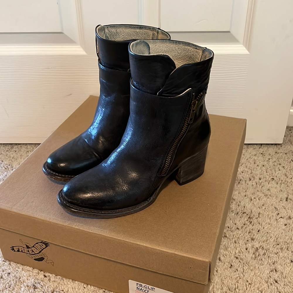 Navy zip up heeled booties.